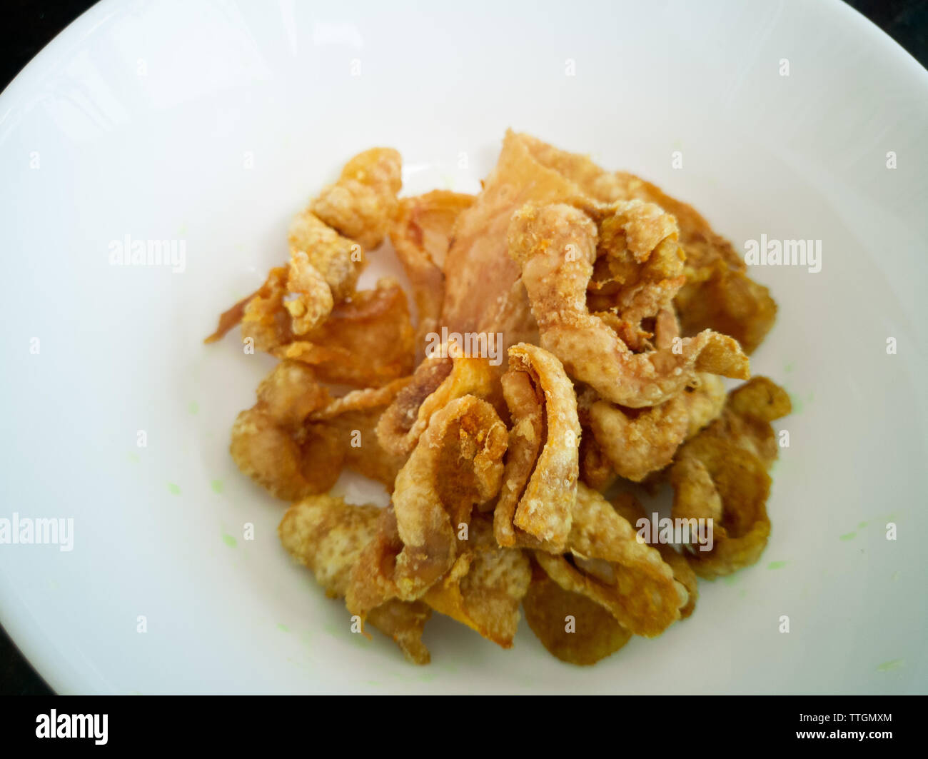 Close up of deepfried chicken skins in a white bowl Stock Photo Alamy