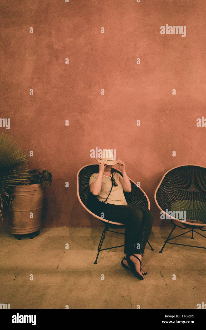 Woman sitting alone chair hi-res stock photography and images - Alamy