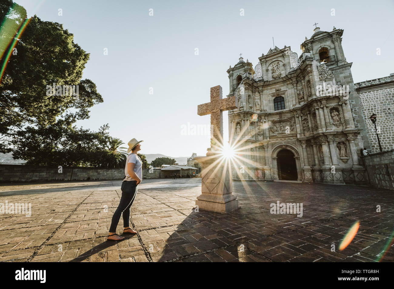 young lady stops to watch sunset at catholic basilica in mexico Stock Photo
