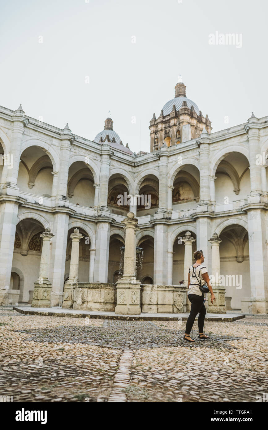 one person walks alone in a white marble museum in oaxaca mexico Stock Photo