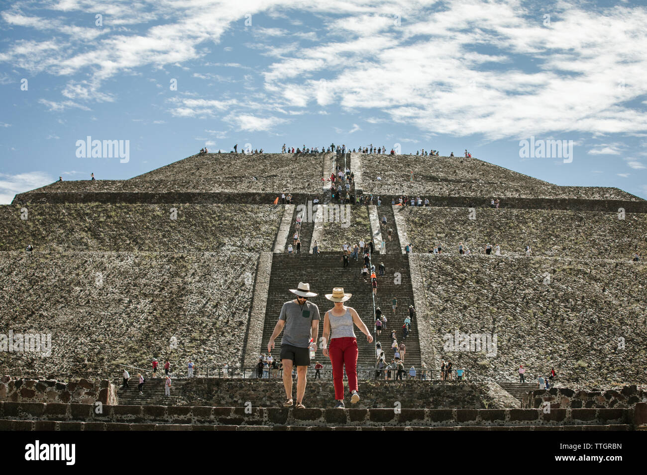 two tourists climb down the pyramid of the sun at teotihuacan mexico Stock Photo