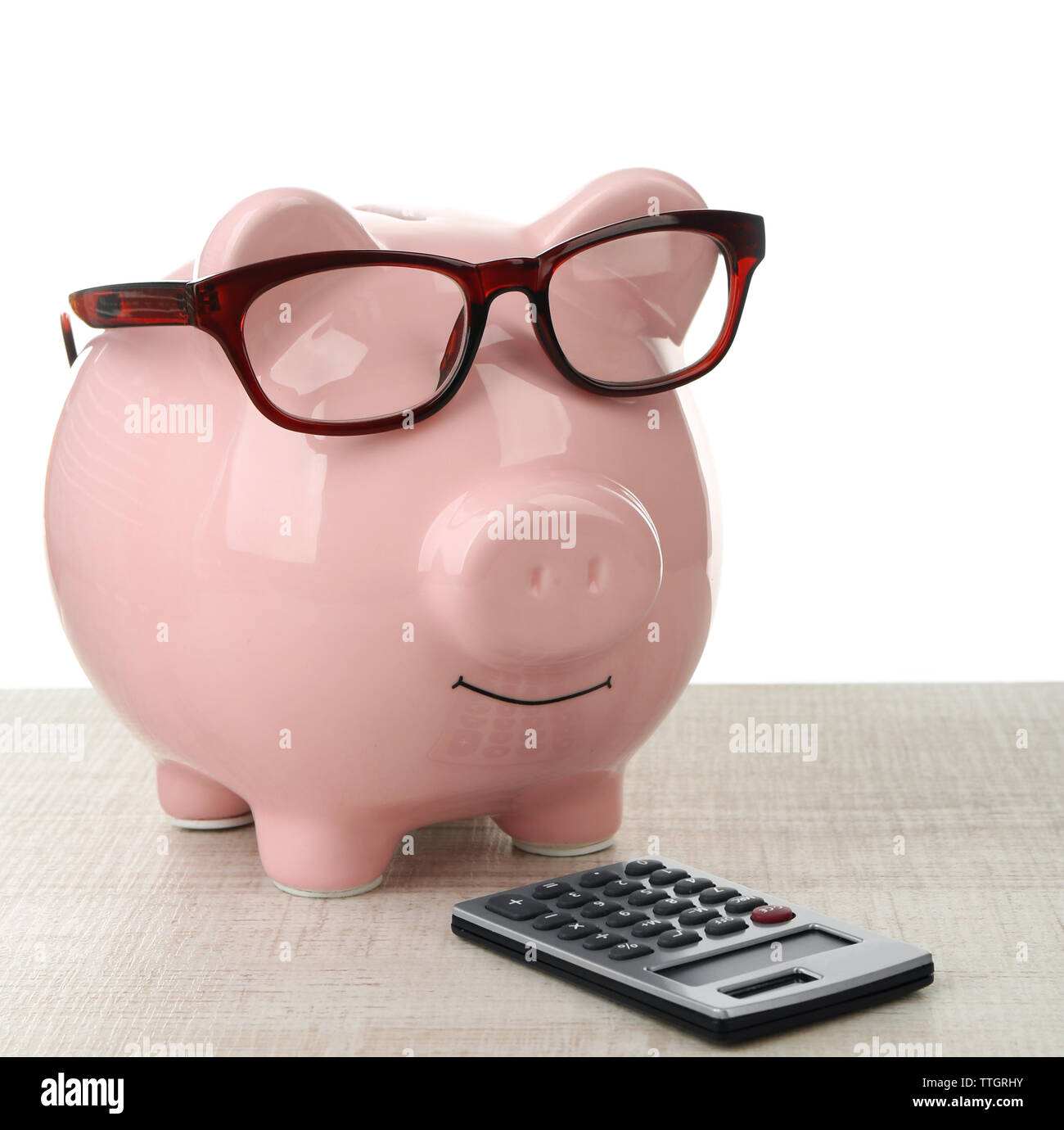 Pink piggy bank with glasses and calculator on white background Stock ...