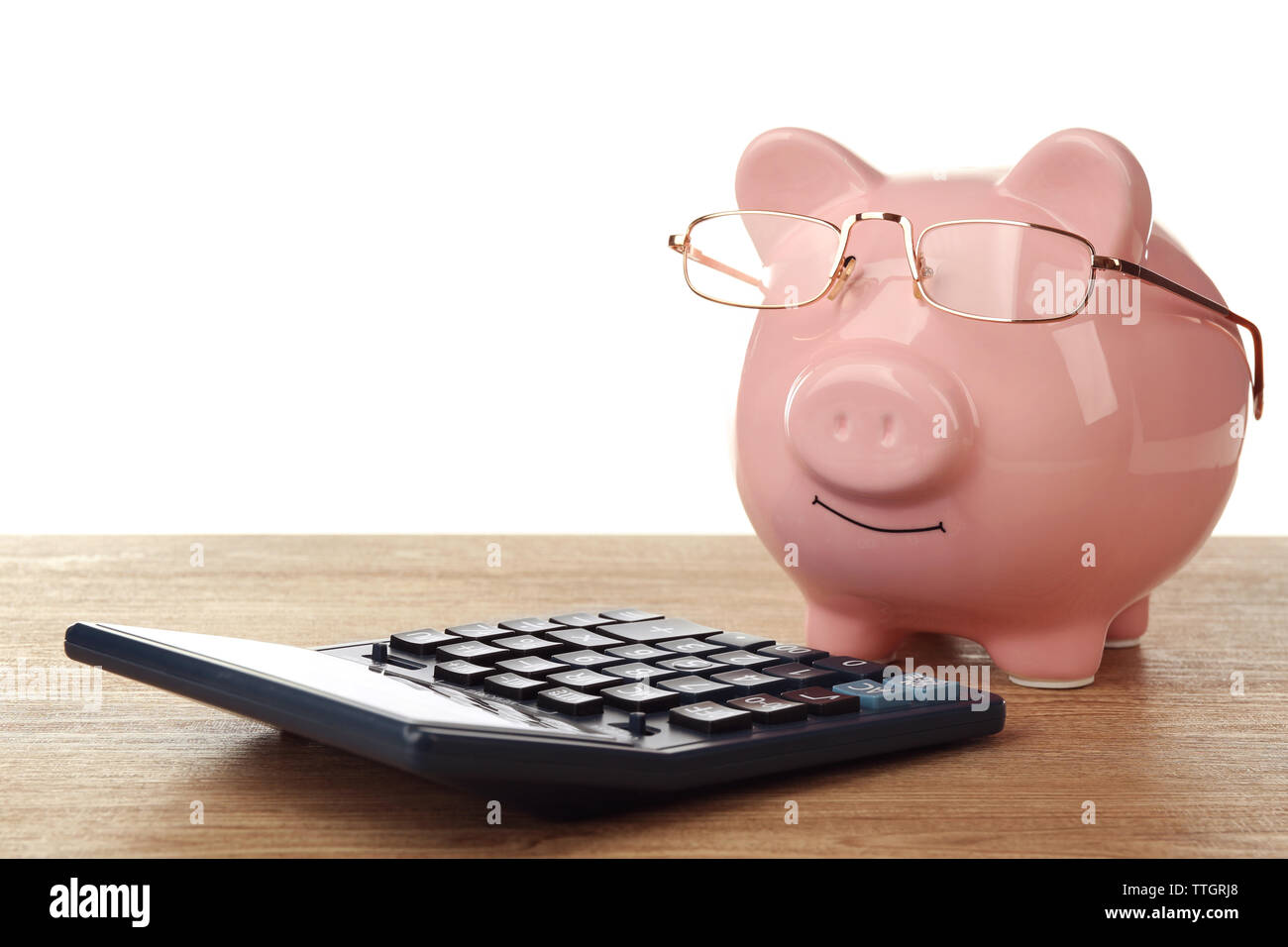 Pink piggy bank with glasses and calculator on white background Stock ...
