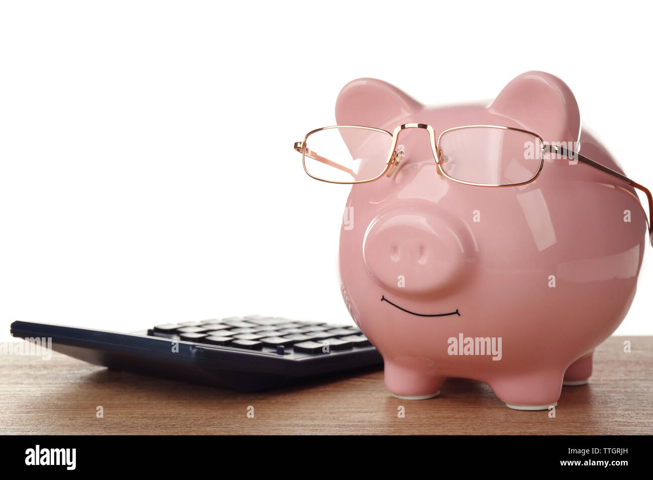 Pink piggy bank with glasses and calculator on white background Stock ...