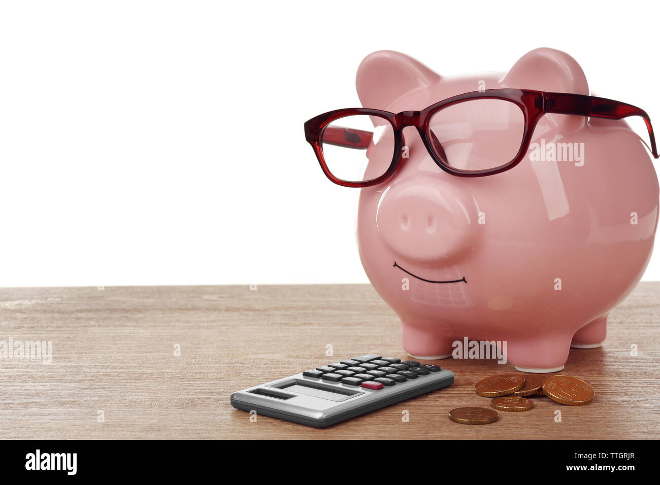 Pink piggy bank with glasses and calculator on white background Stock ...
