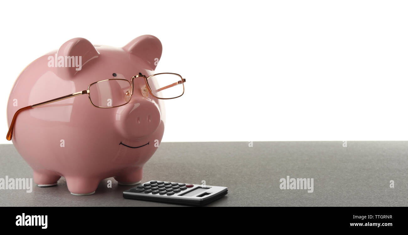 Pink piggy bank with glasses and calculator on white background Stock ...