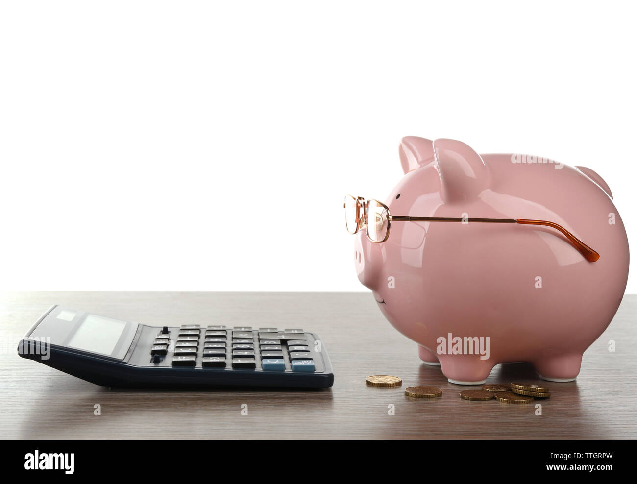 Pink piggy bank with coins, glasses and calculator on white background ...