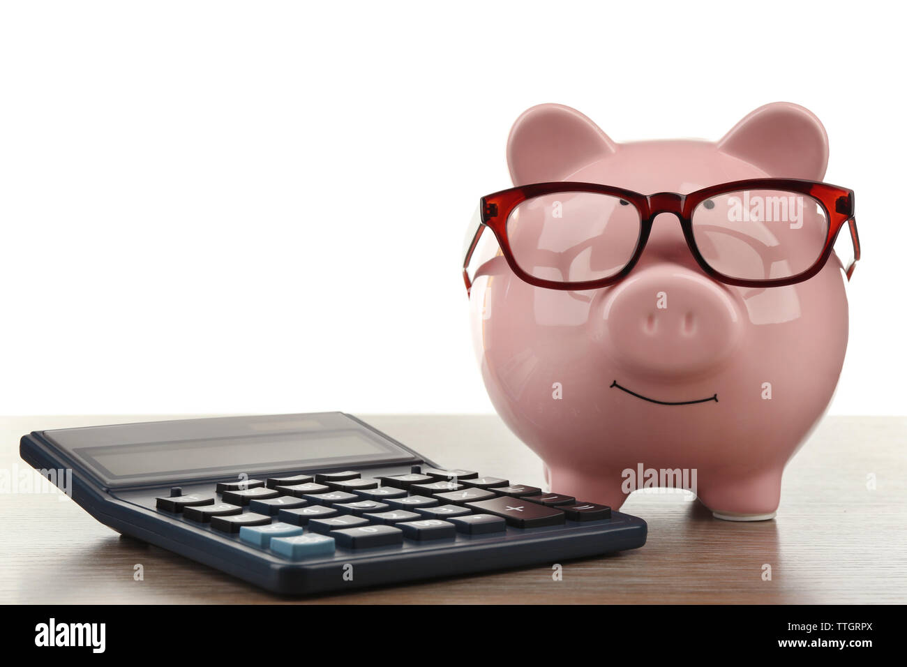 Pink piggy bank with glasses and calculator on white background Stock ...