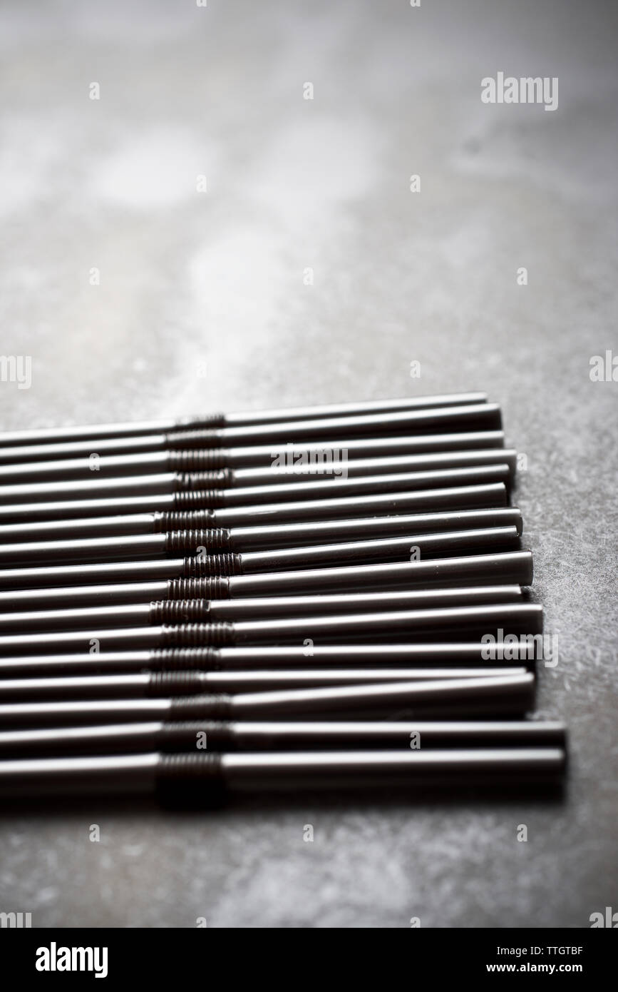 Drinking straws on a black table Stock Photo