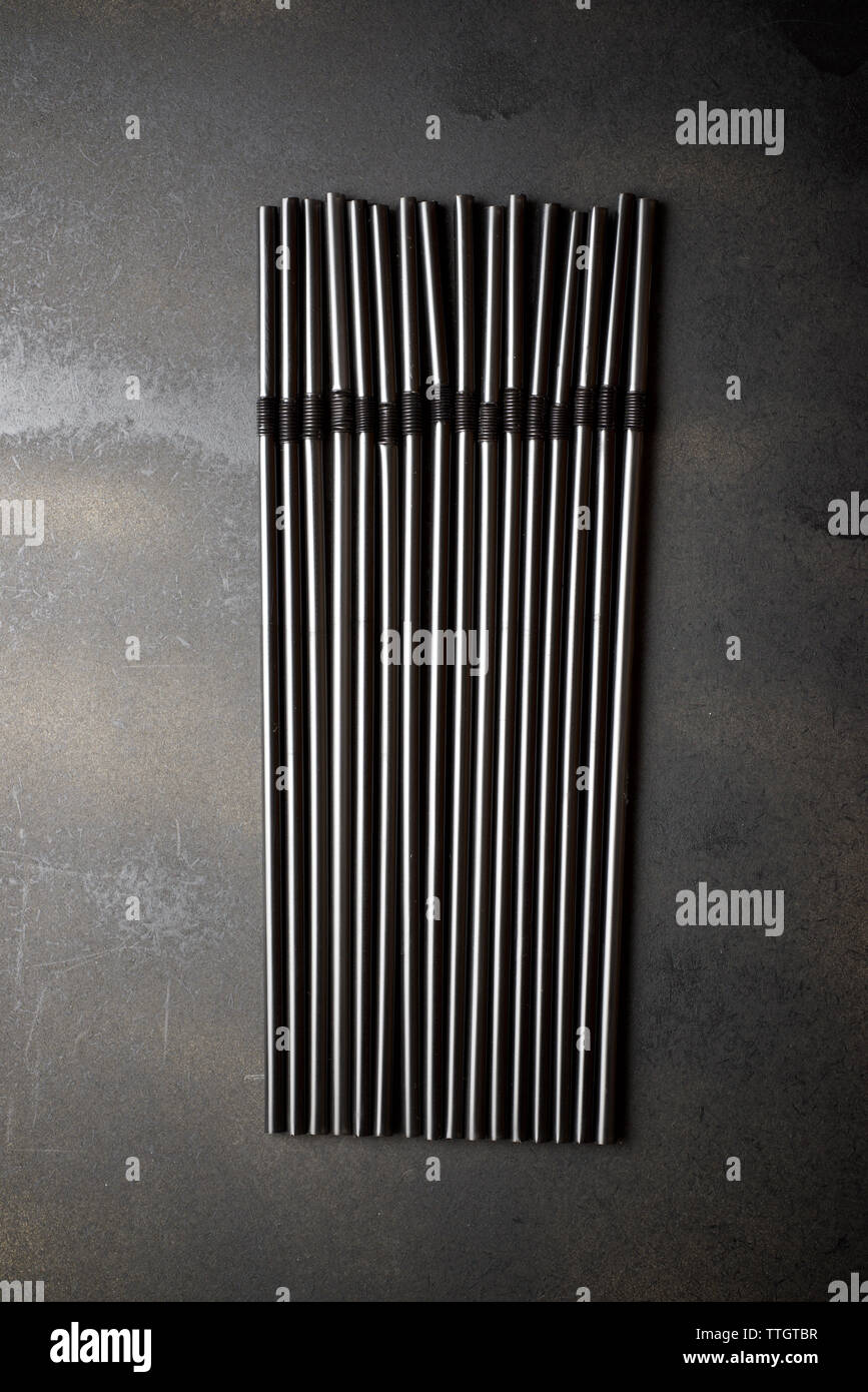 Drinking straws on a black table Stock Photo