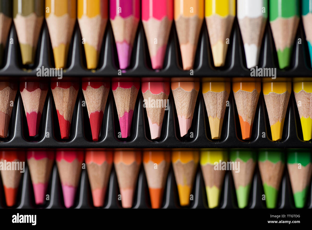 Watercolor pencils lined up in a black plastic box. Stock Photo
