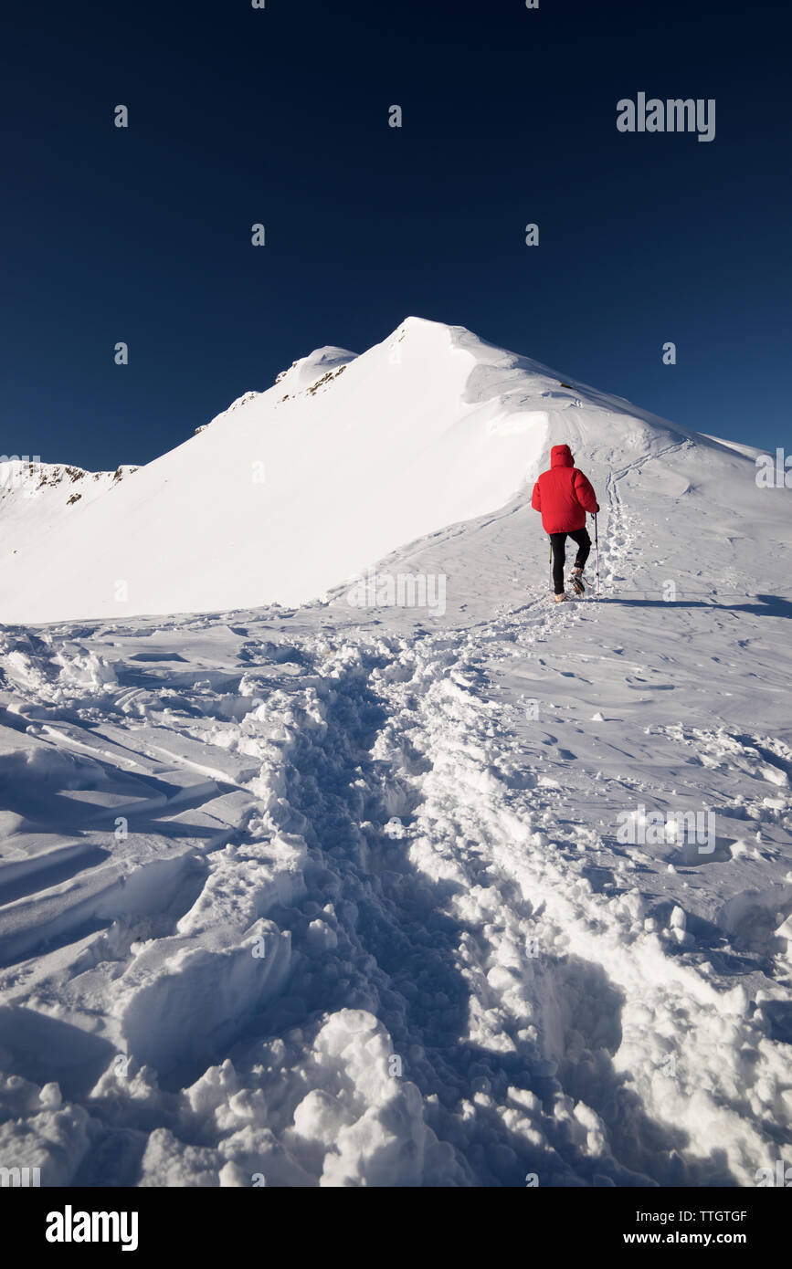 Mountaineer hiking in the Pyrenees in winter season. Stock Photo