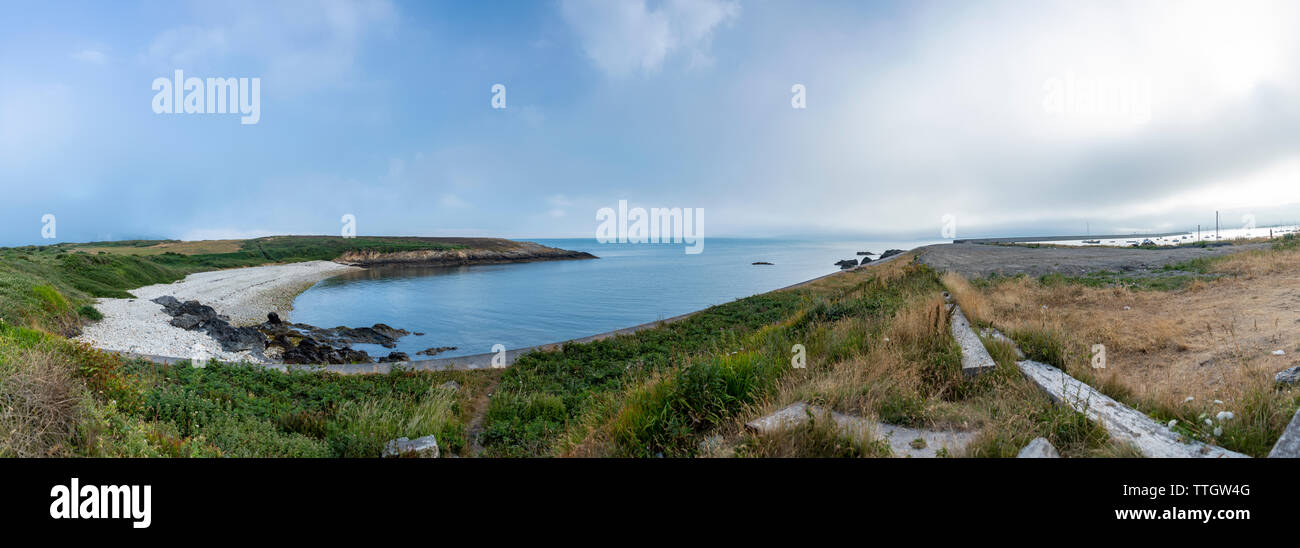 Panoramic view of sea bay and green pasture in Wales. Stock Photo