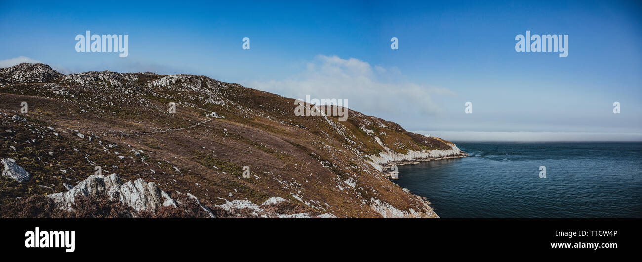 The panoramic view of white cliffs in Wales overgrown with grass. Stock Photo