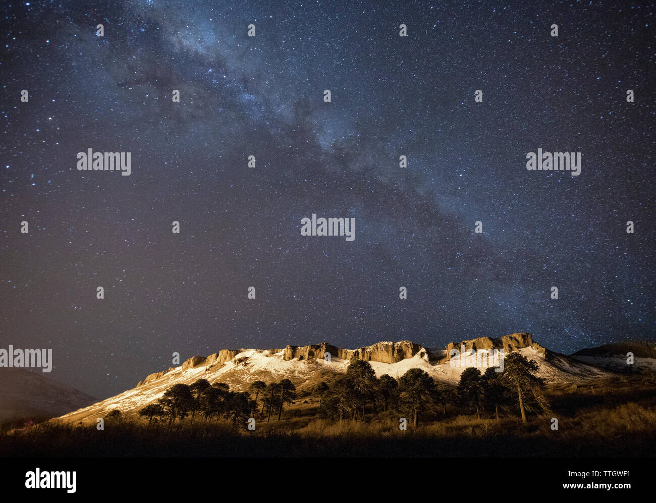 The Milky Way shines brightly above the town of Caviahue, Argentina. Stock Photo