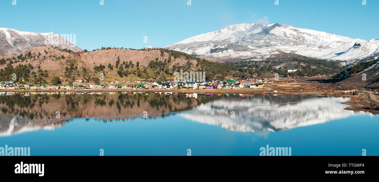 The town of Caviahue sits on the side of a lake below Volcan Copahue. Stock Photo