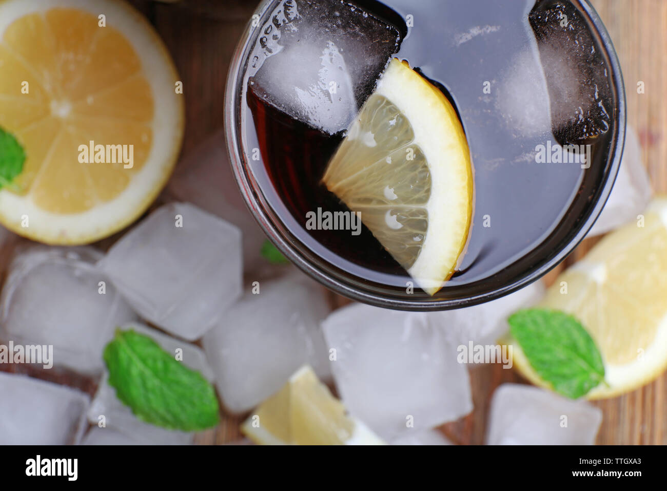 Glass of cola with cubes of ice and lemon , closeup Stock Photo - Alamy