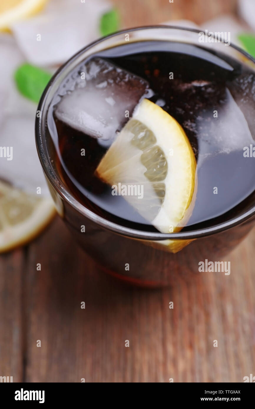 Glass of cola with cubes of ice and lemon , closeup Stock Photo - Alamy