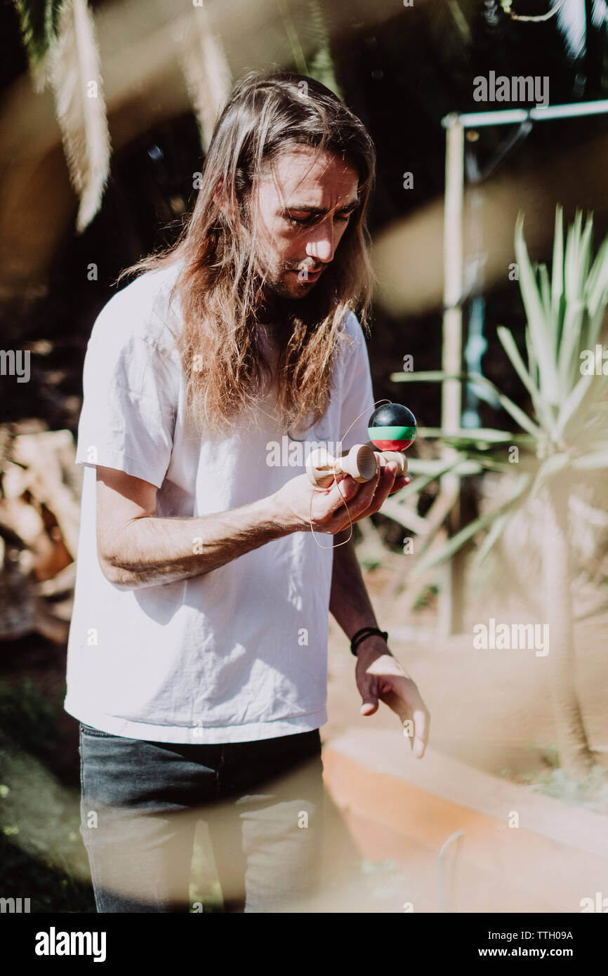 A man playing with Kendama in a park in Tenerife Stock Photo