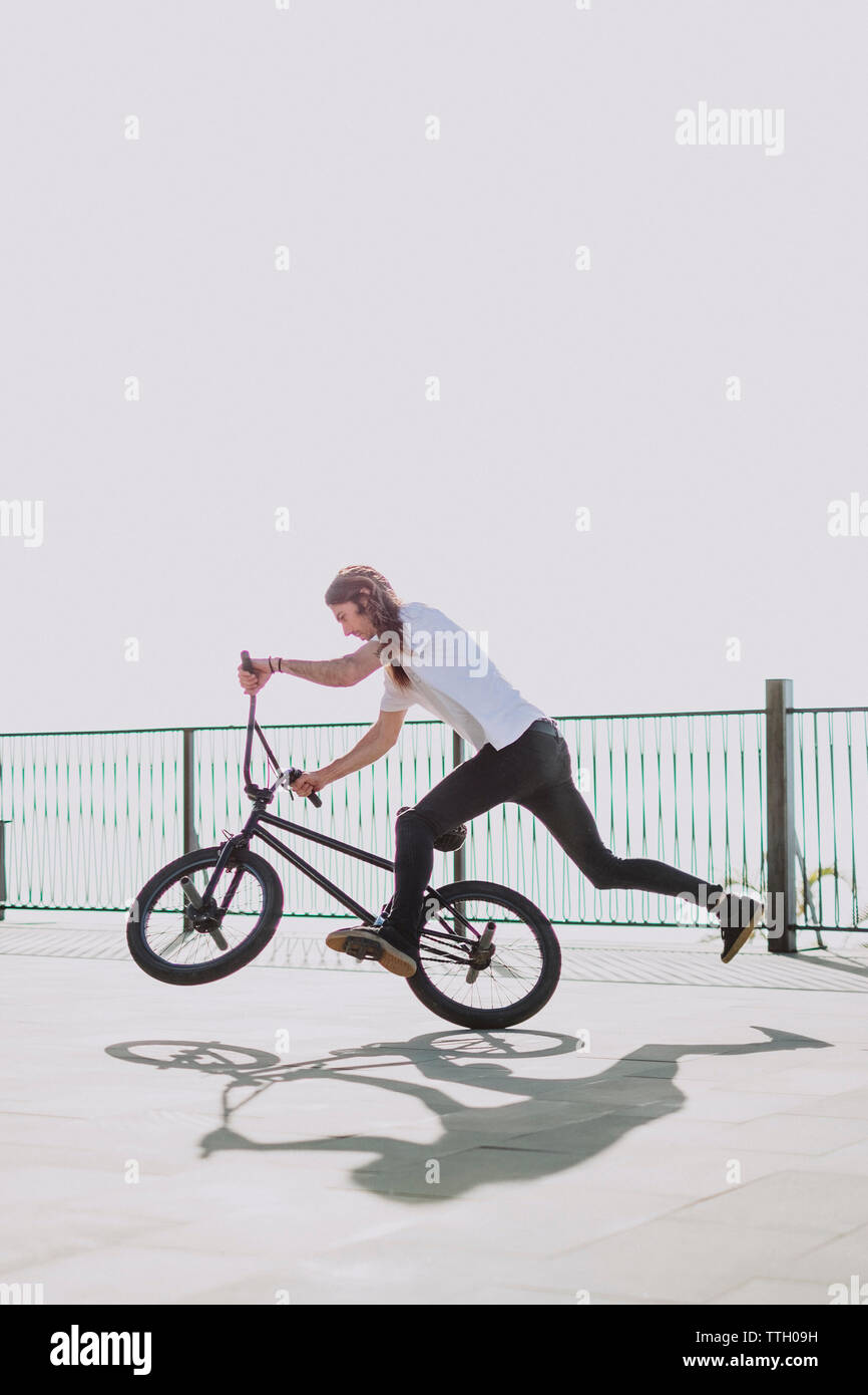 A man riding fast with his bmx bike in a square Stock Photo