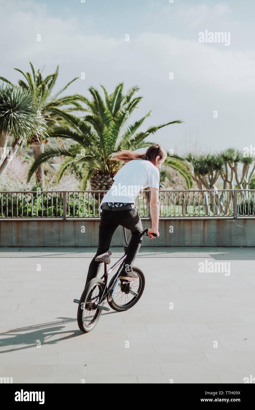A man ride his bmx bike in a square in Tenerife Stock Photo