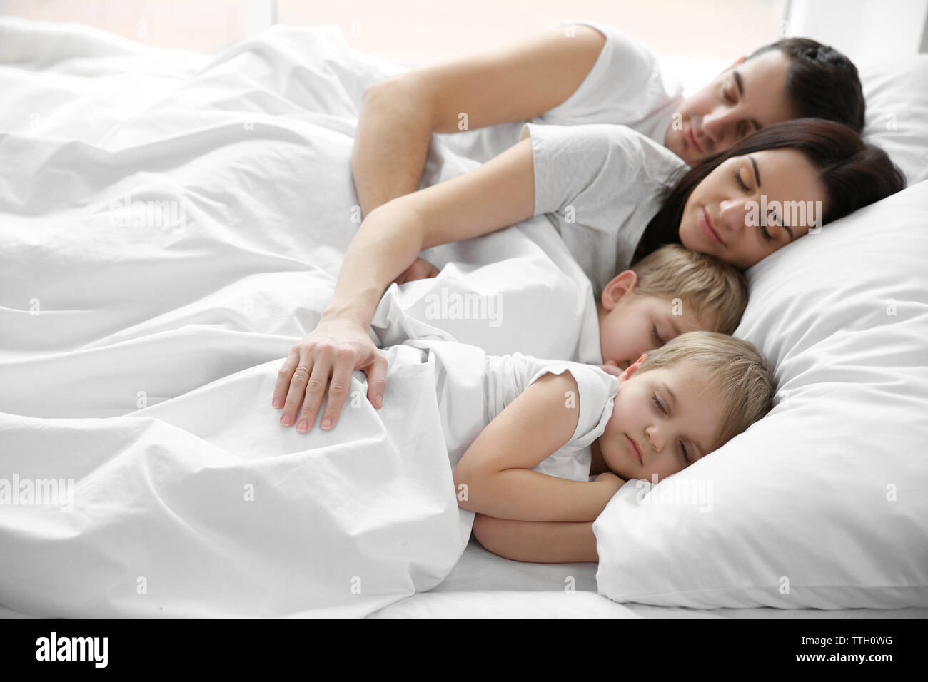 Family sleeping in bed, closeup Stock Photo - Alamy