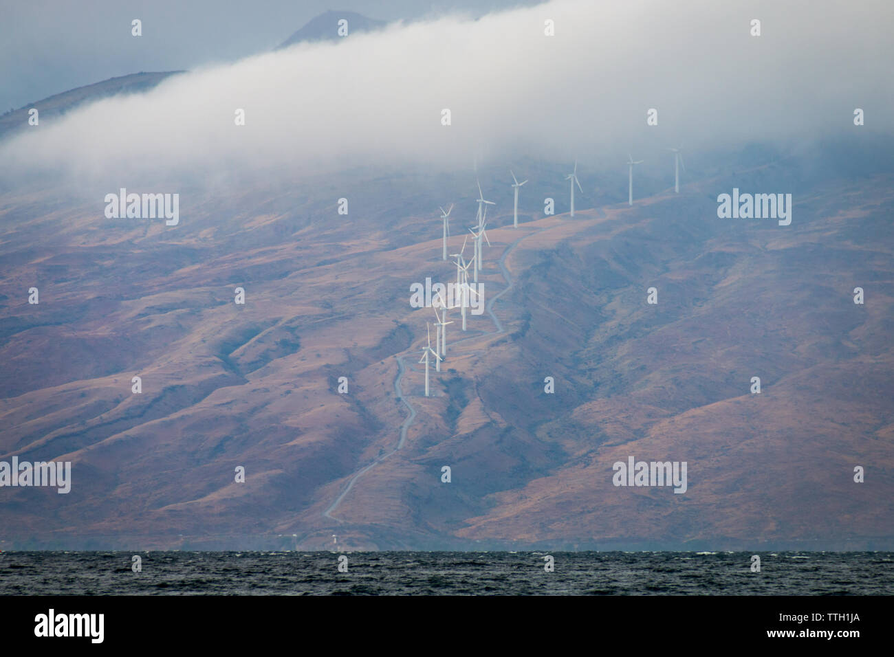 Modern windmills on the Hawaiian island of Maui generating clean energy Stock Photo