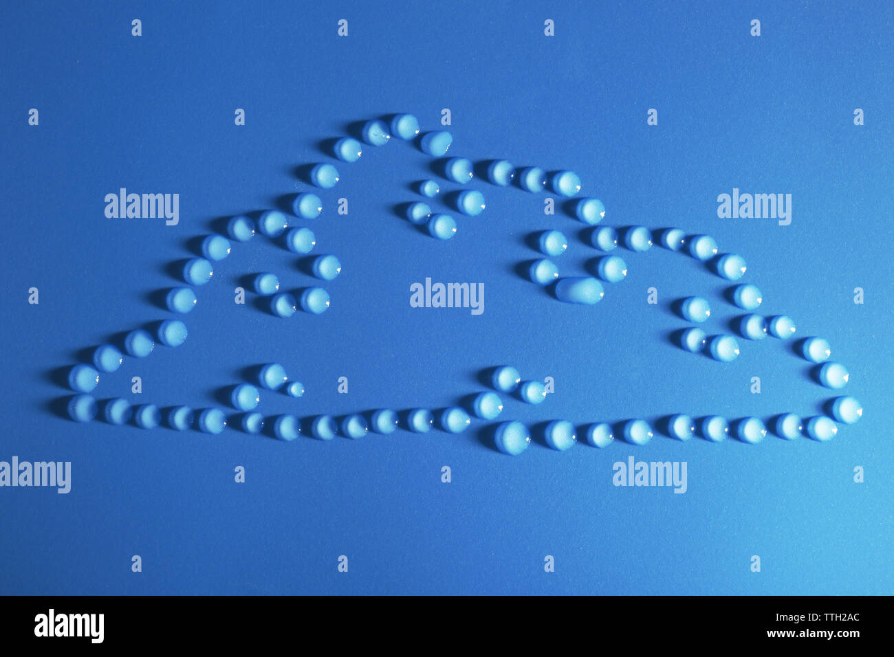 Cloud made of water drops on blue background Stock Photo - Alamy