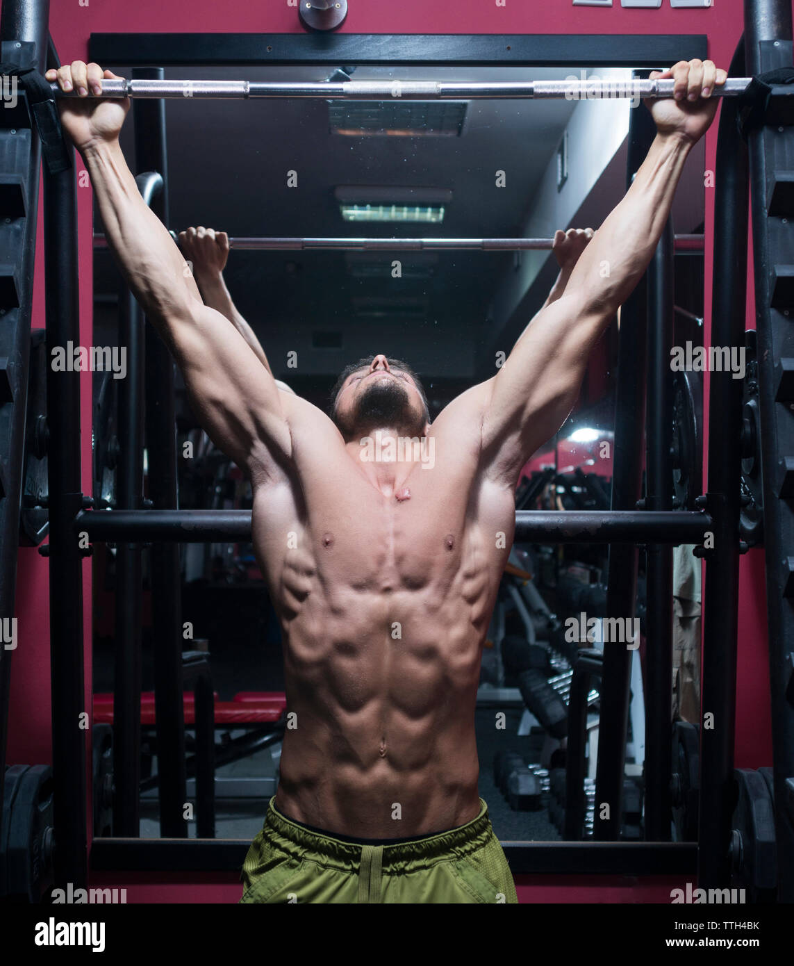 Man working out doing chin ups in the gym Stock Photo