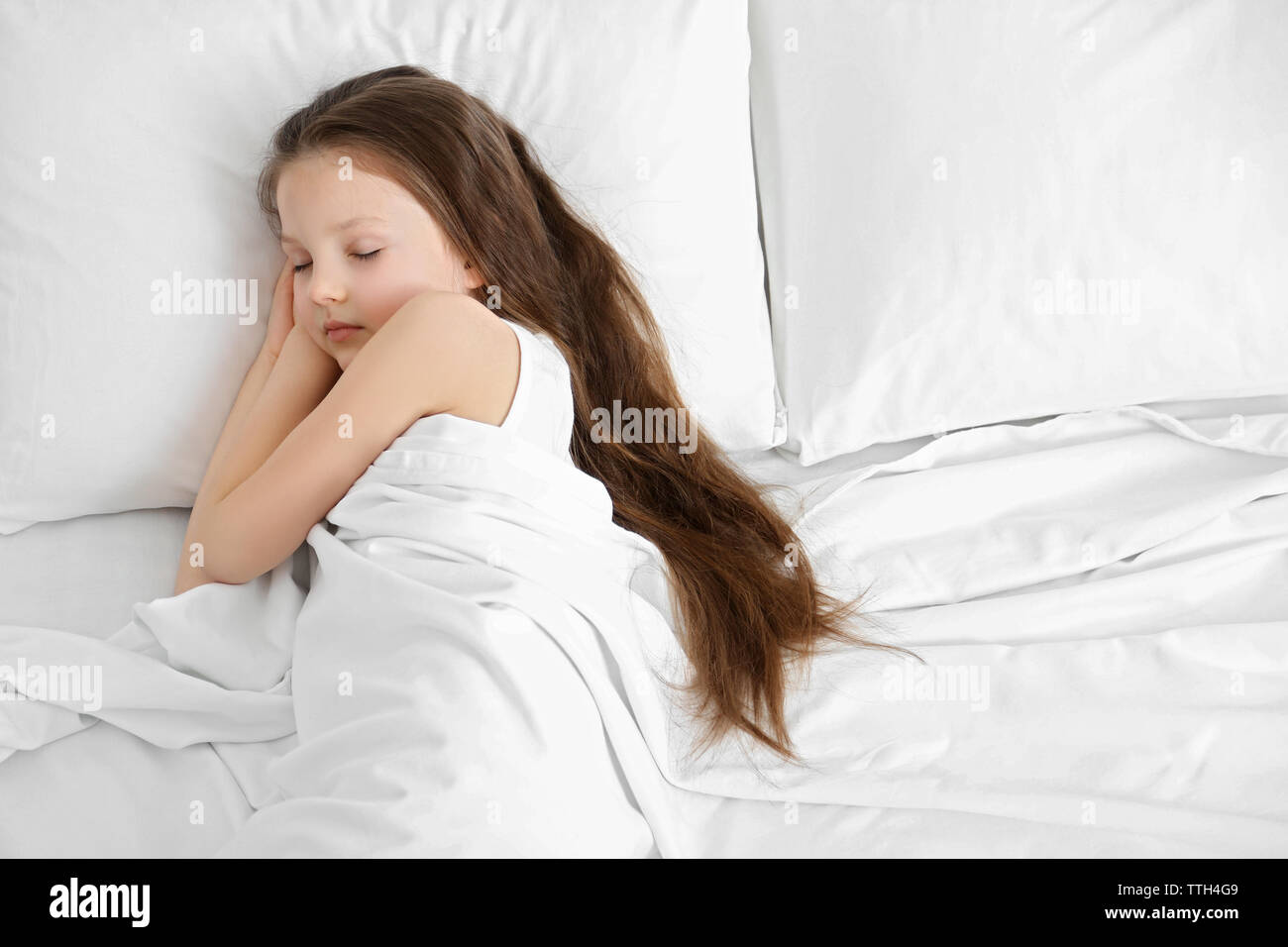 Little girl sleeping in bed Stock Photo - Alamy