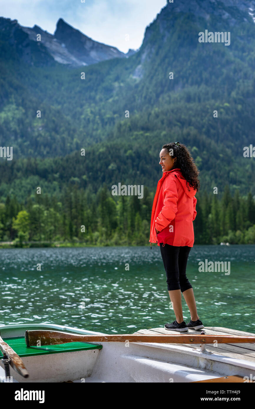 Woman standing on landing stage watching the landscape and smiling Stock Photo
