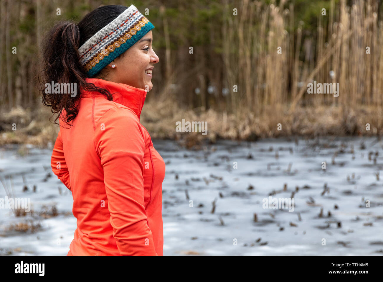 Woman in the outdoors enjoying nature and smiling on a autumn day Stock Photo