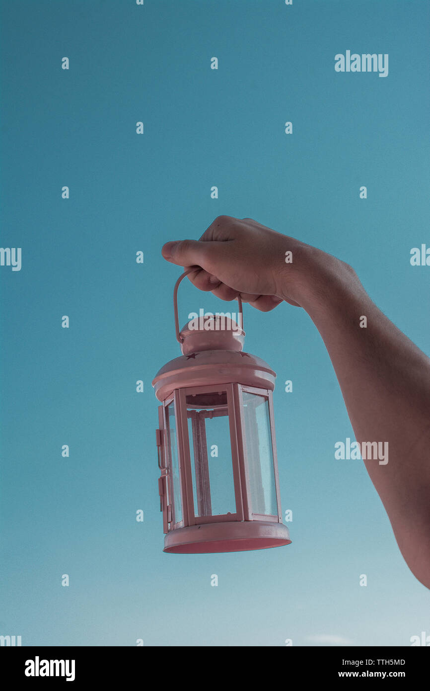 Old retro style lantern made of metal in hand Stock Photo - Alamy