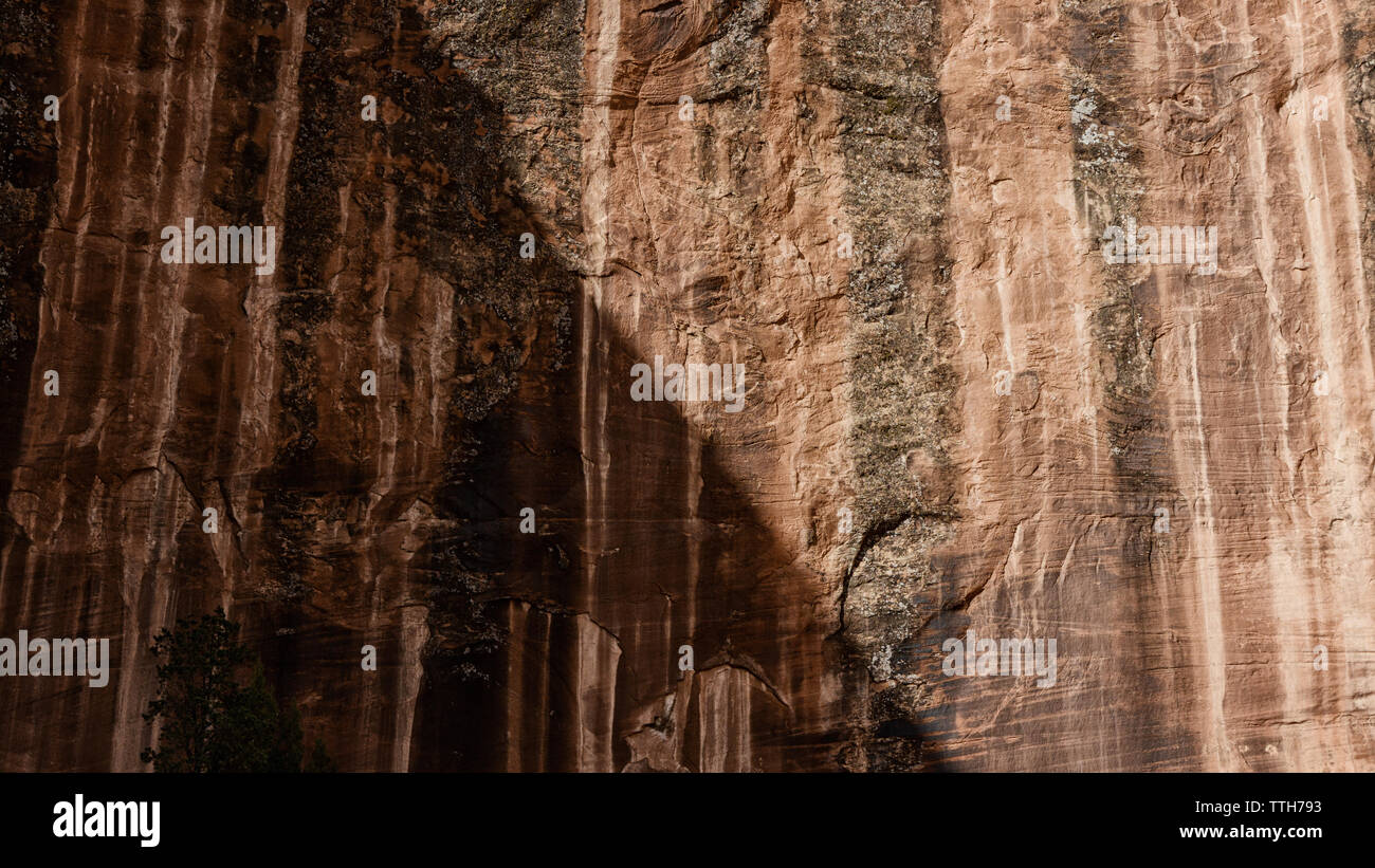 Moab slickrock half in shadow with oxidization pattern Stock Photo