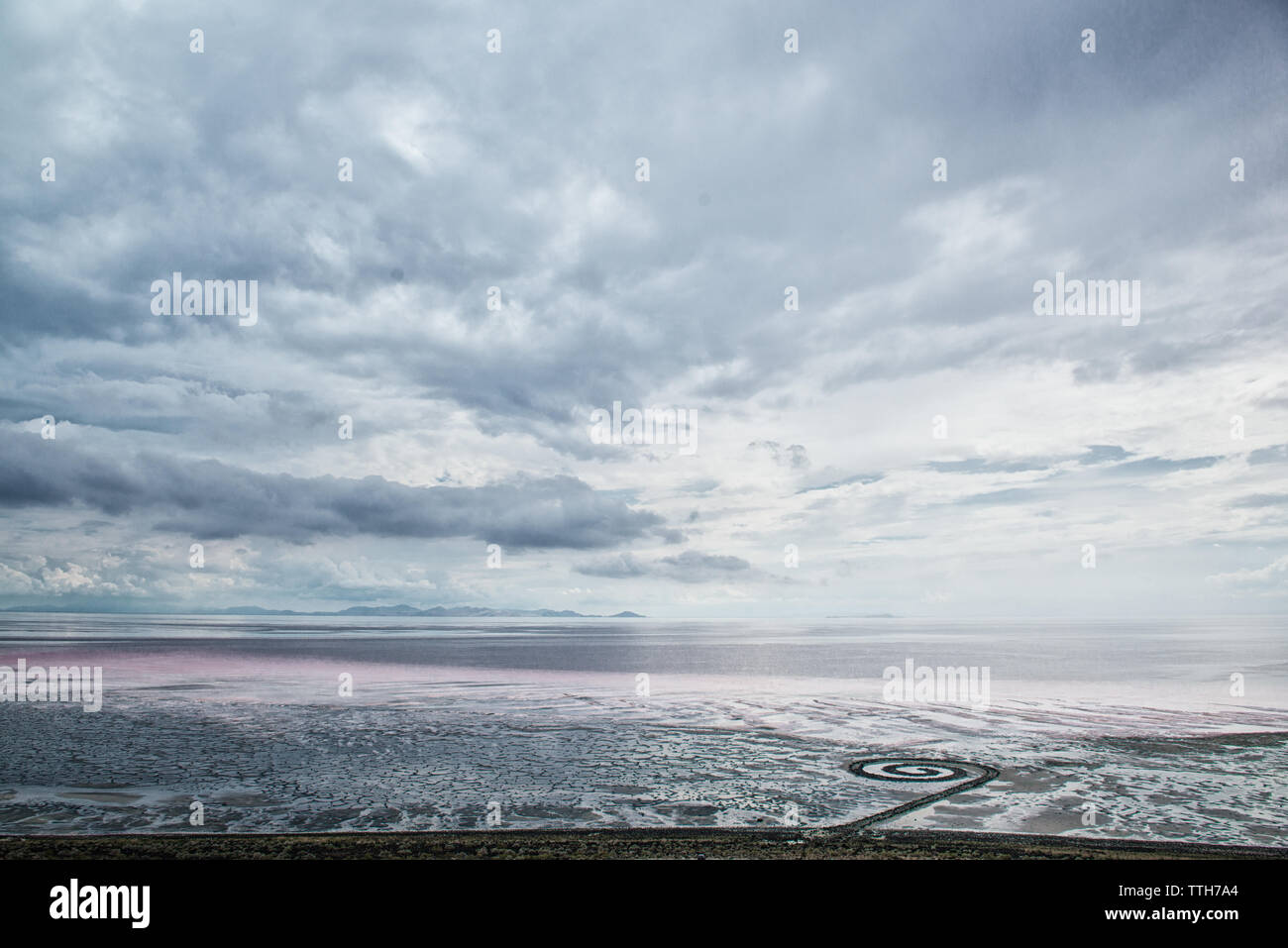 Landscape of Spiral Jetty with bacterial color layers in backgrounnd Stock Photo