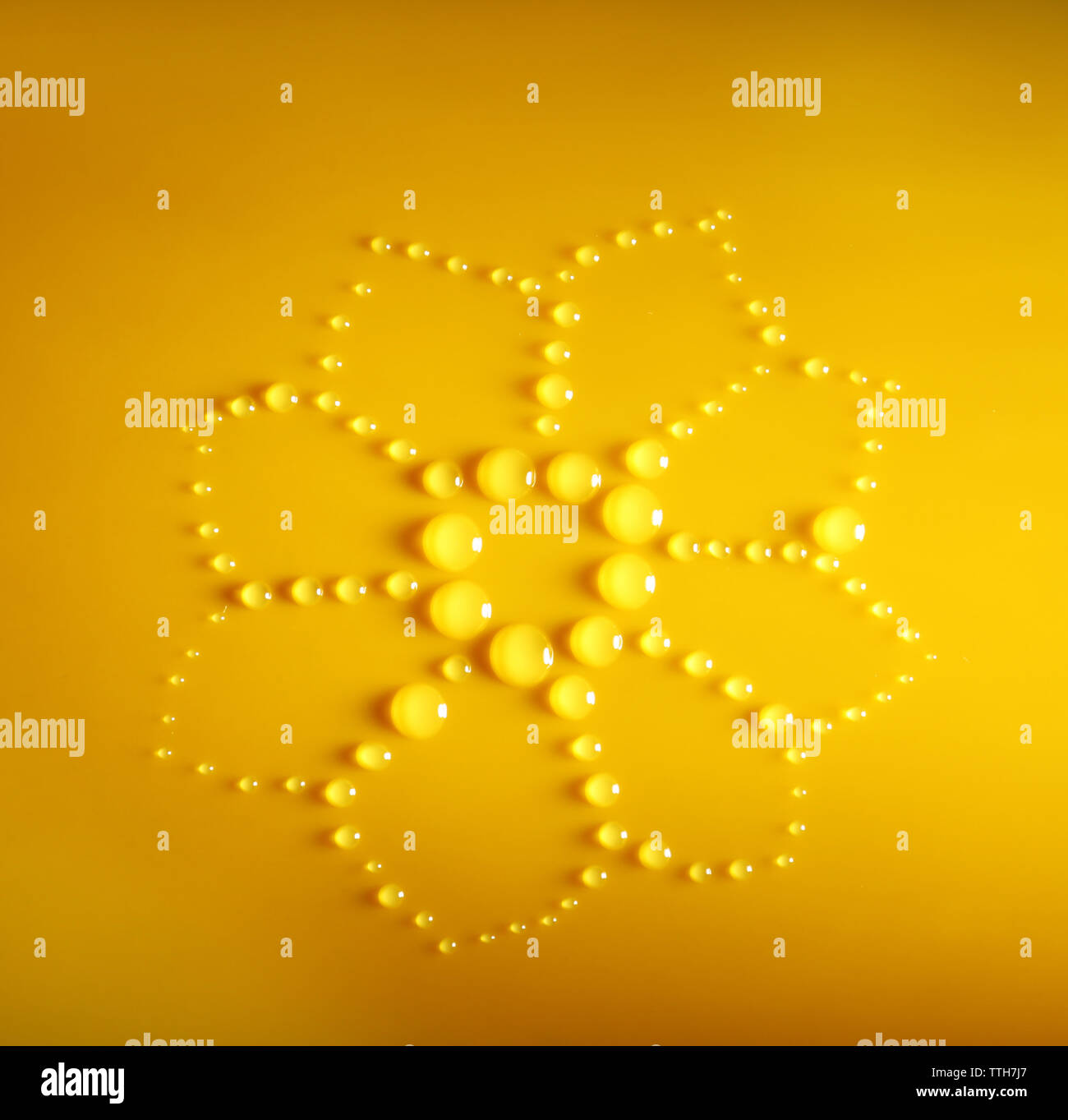 Water drops on a yellow surface, top view Stock Photo - Alamy