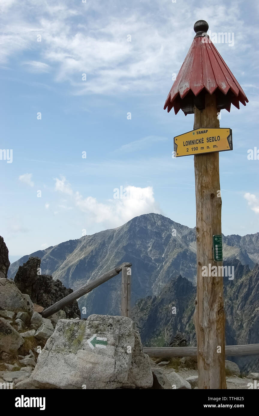 Tatranska Lomnica, Slovakia - August 4, 2013: Wooden signpost on a path in the High Tatras Mountains in a summer. Stock Photo