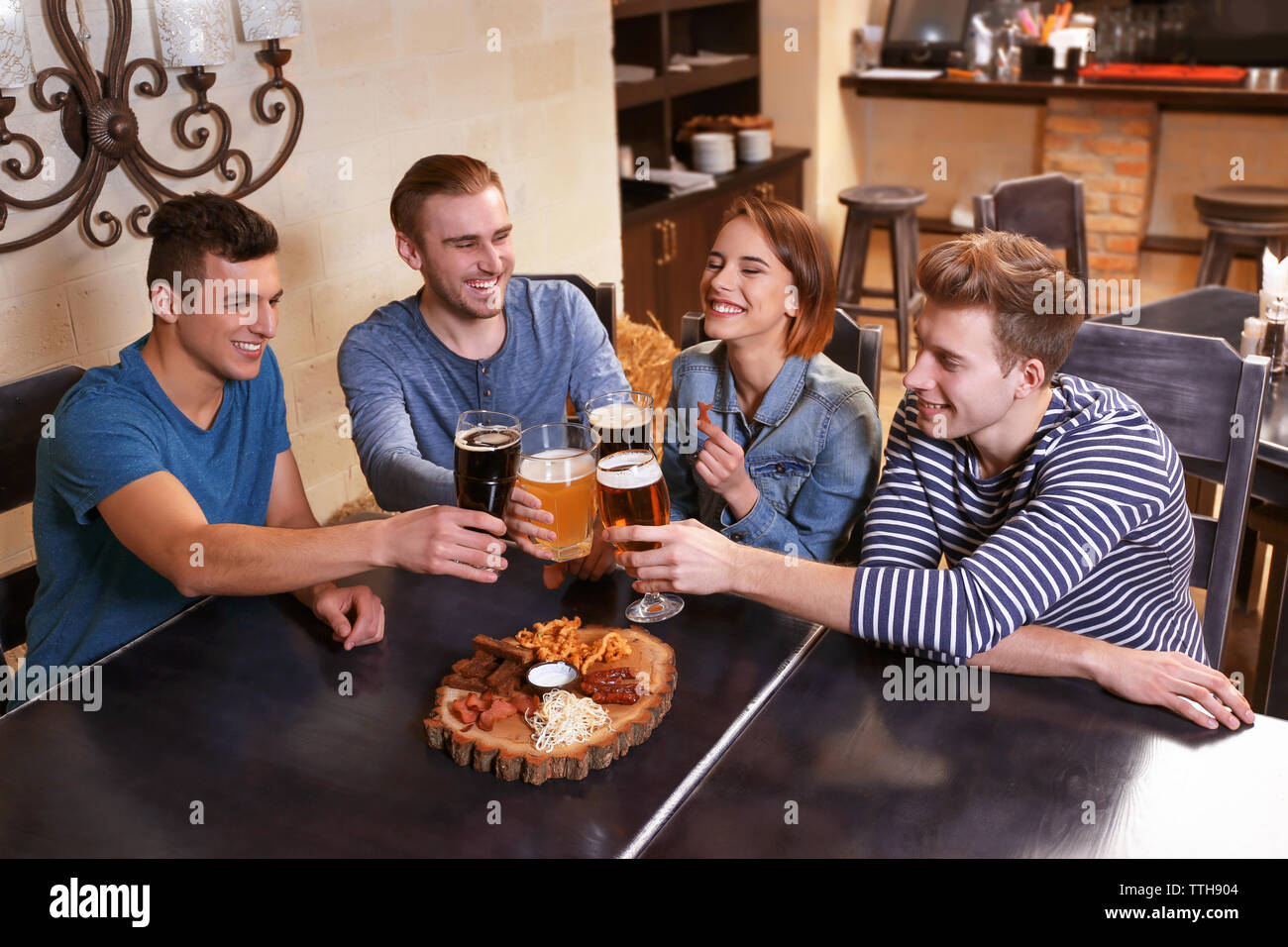 Bar Spend Group of young people spending time in bar Stock Photo - Alamy