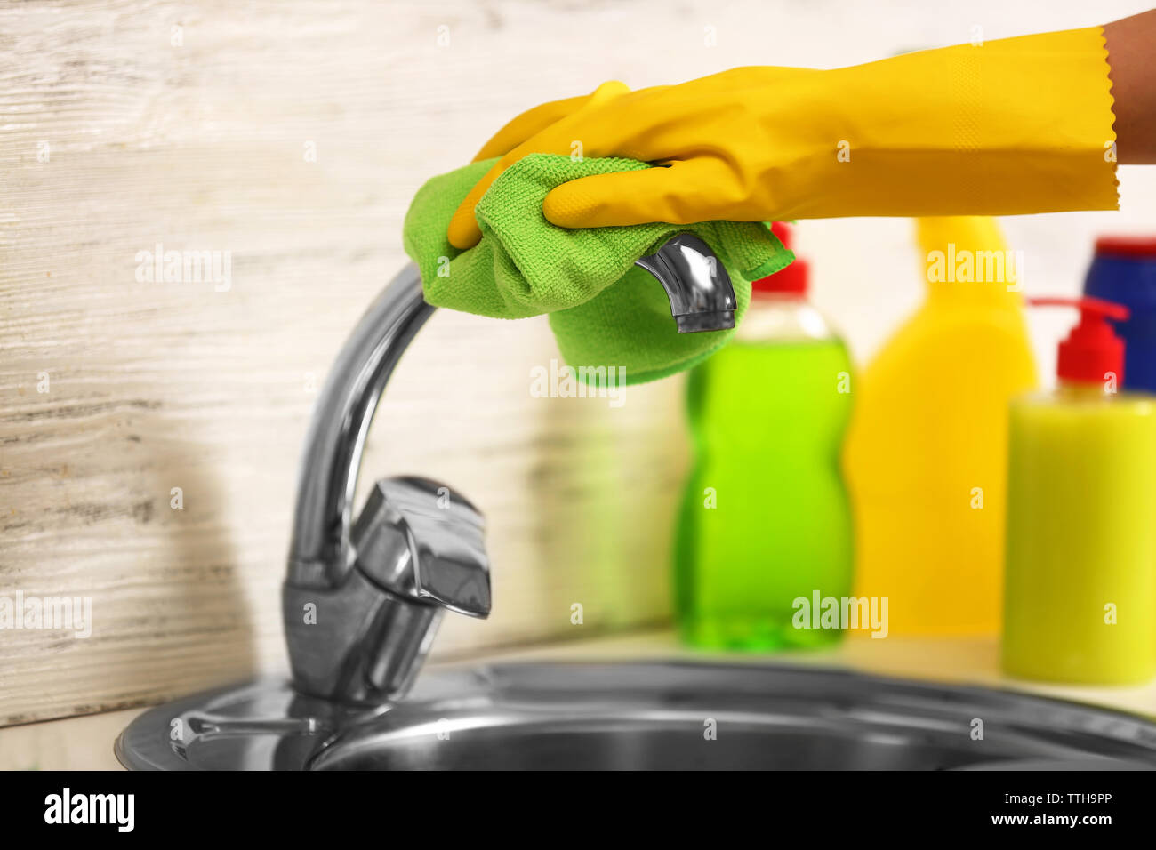 Female hand with rag cleaning a tap in the kitchen Stock Photo - Alamy