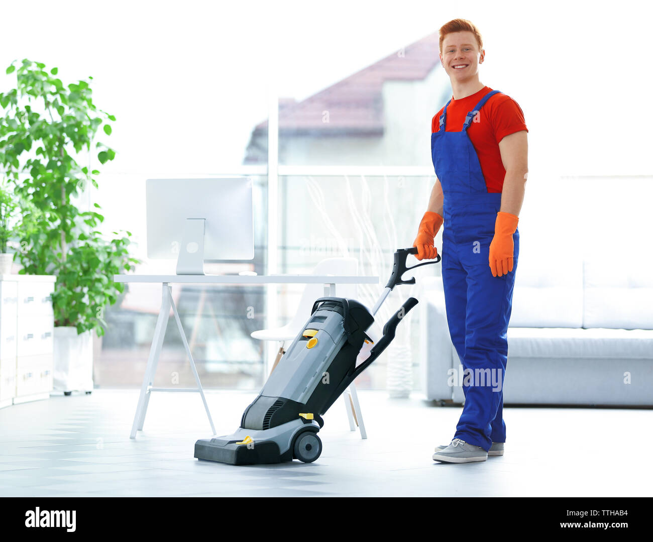 Young janitor with washing machine cleaning floor in office Stock Photo Alamy