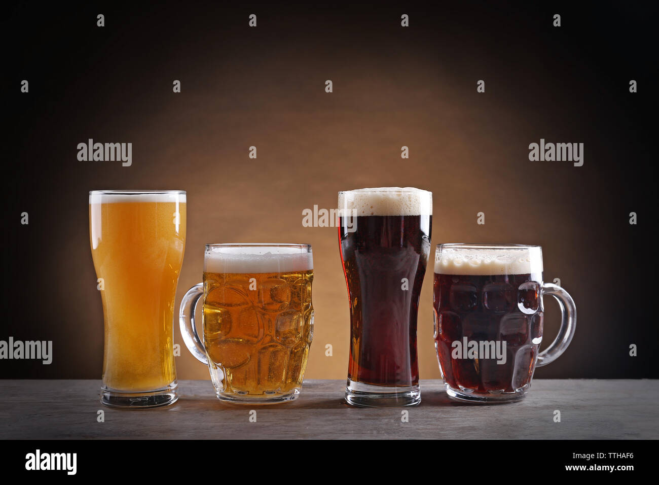 Different sorts of draft beer in glasses on wooden table Stock Photo
