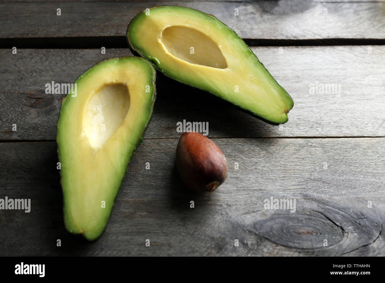 Sliced avocado on wooden table Stock Photo - Alamy