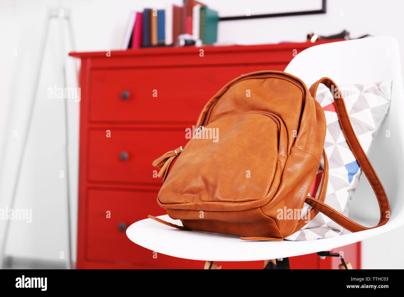 Brown leather backpack on the chair. Stock Photo