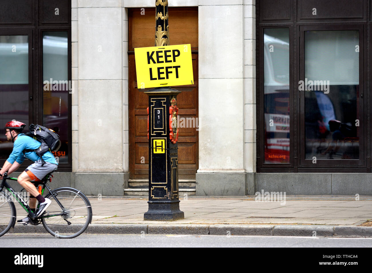 London, England, UK. Keep Left sign in Fleet Street. Cyclist passing by Stock Photo