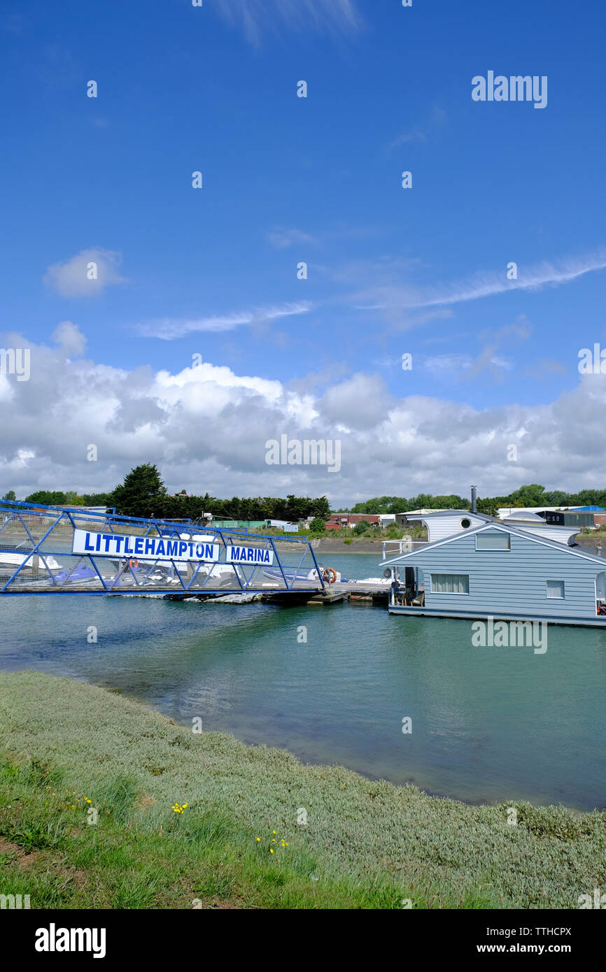 Early Summer. Littlehampton Marina, Littlehampton, West Sussex. Marina sign on bridge leading down to houseboat Stock Photo