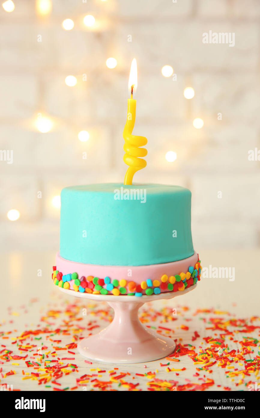 Birthday cake with one candle on white background Stock Photo - Alamy