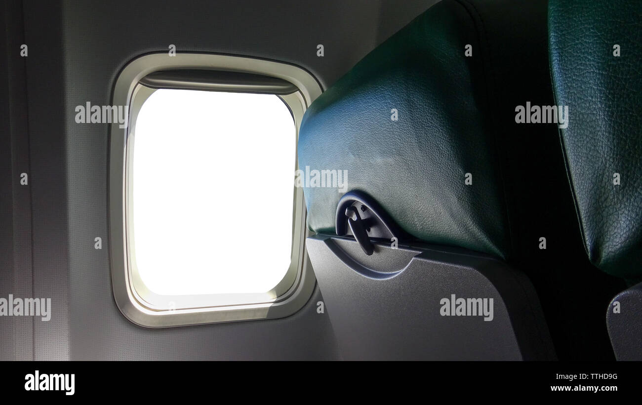 Airplane window seat with isolated white window inside the aircraft