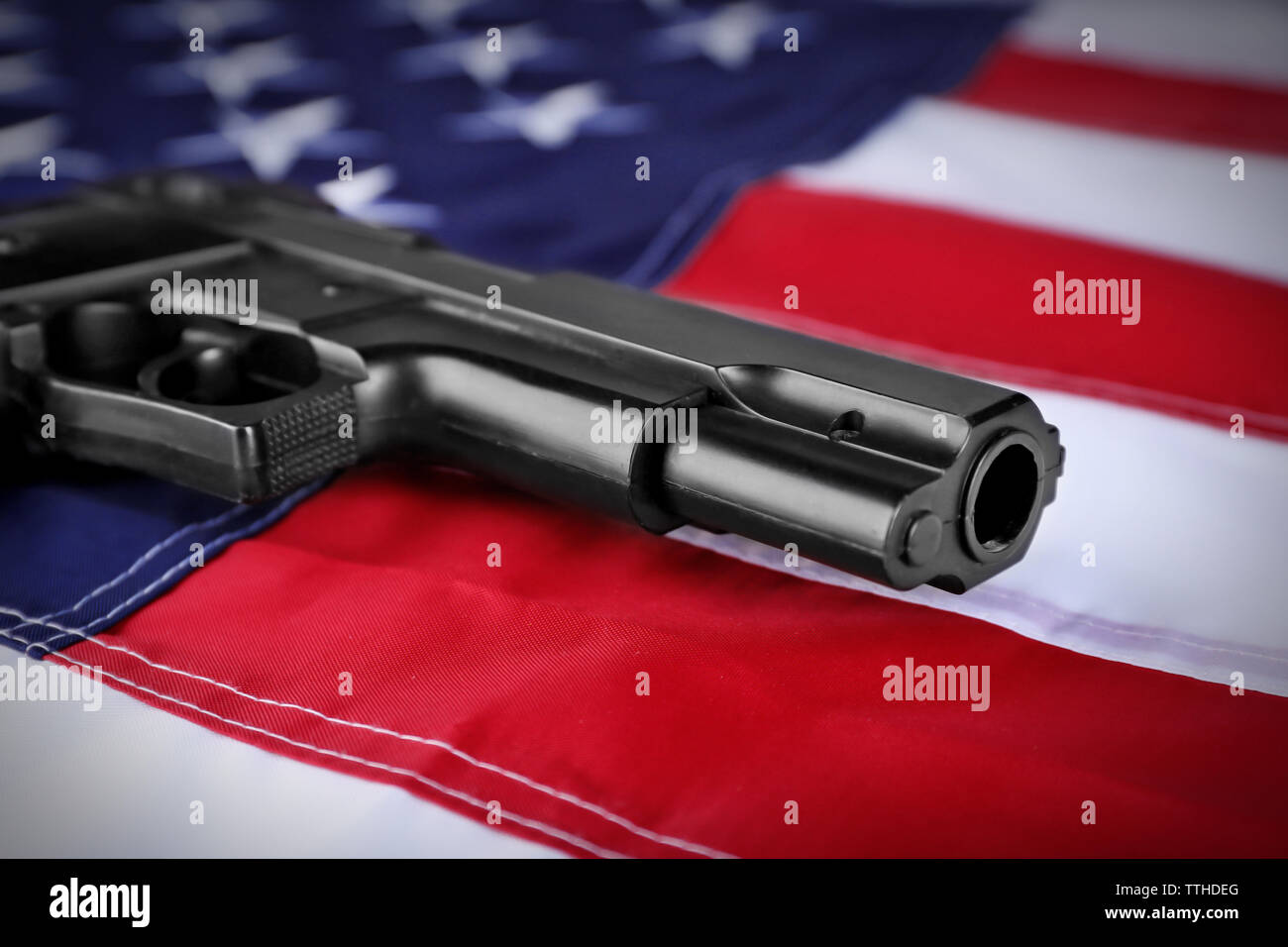 Gun on background of USA flag Stock Photo - Alamy
