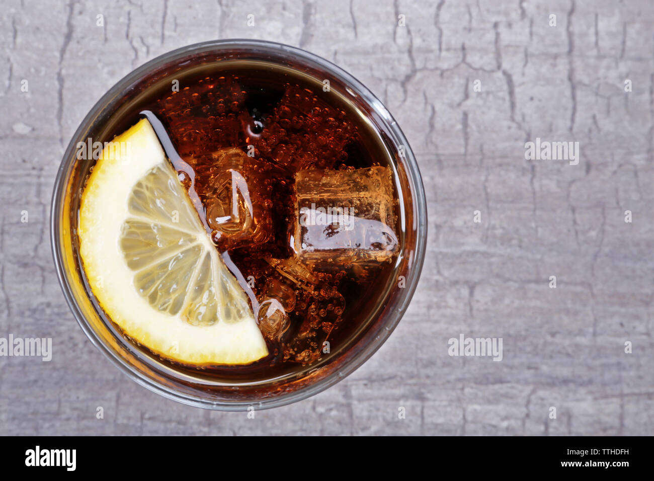 Glass of cola with ice and lemon on rustic wooden background Stock ...