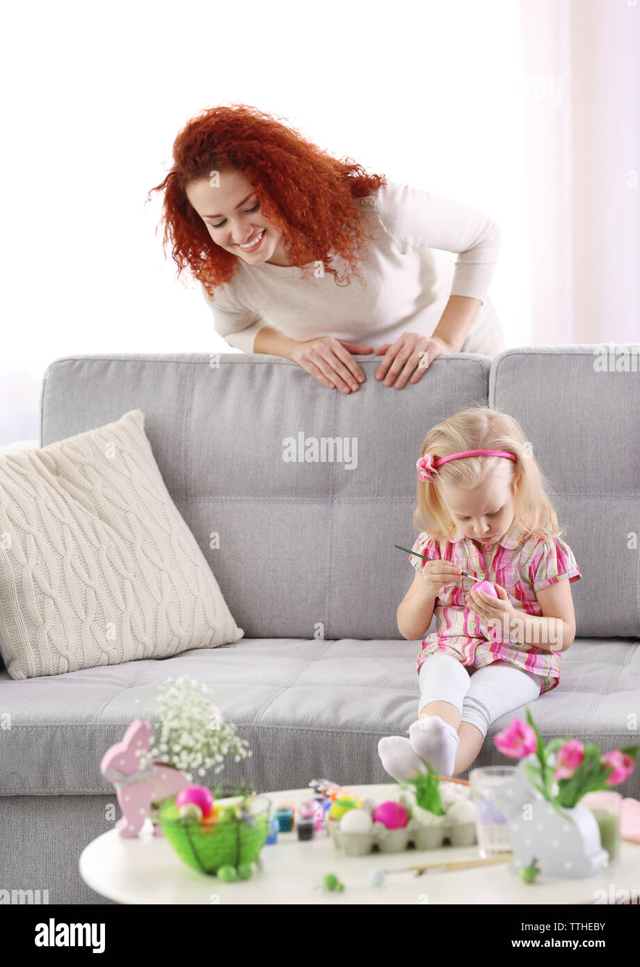 Mother and daughter decorating Easter eggs, indoors Stock Photo